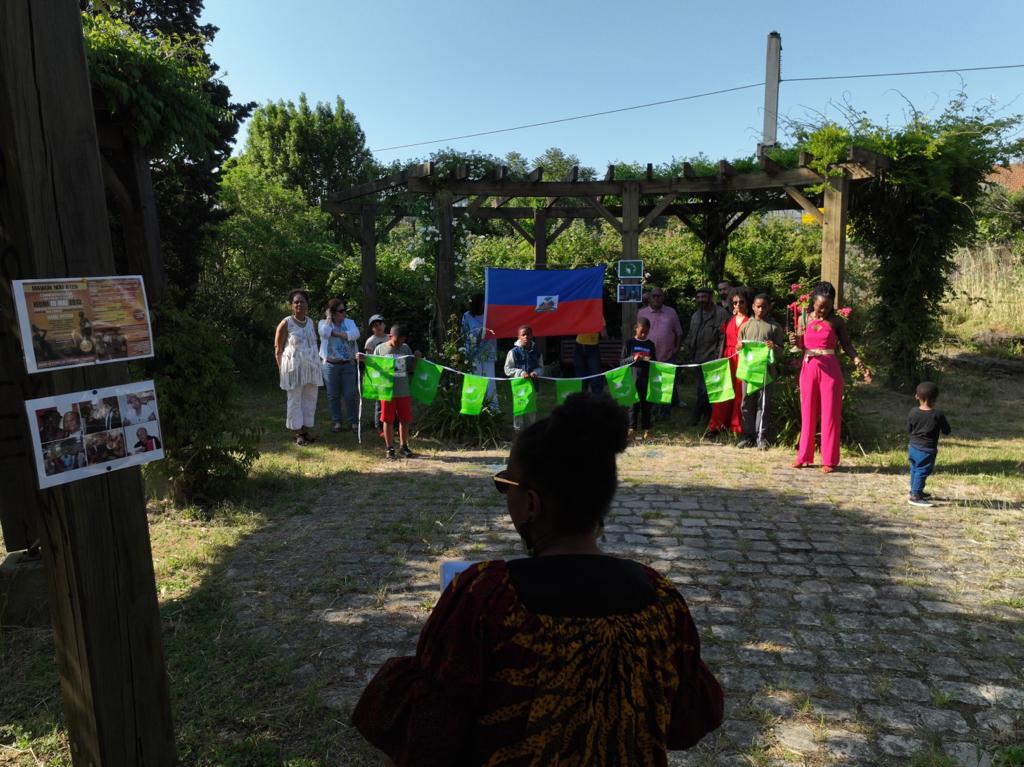 Photo de groupe pour célébrer l'African Liberation Day. En toile de fond le drapeau haïtien.